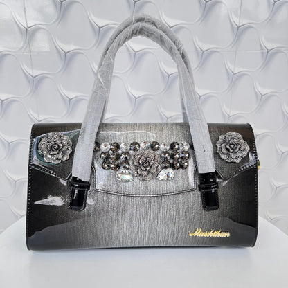 Designer shining leather handbag with stonework