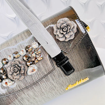 Designer shining leather handbag with stonework