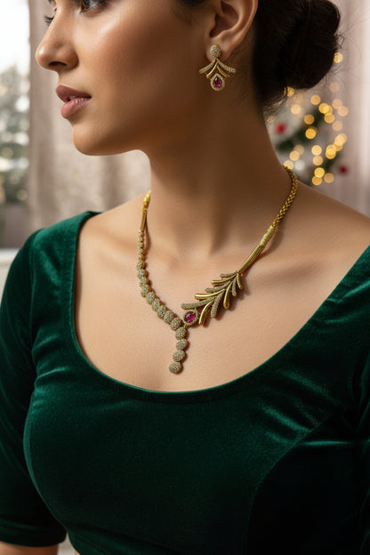 Gold necklace with red gemstones on a gray mannequin bust