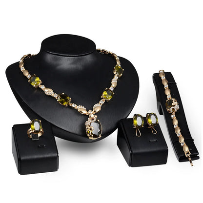 Jewelry set including necklace, earrings, and bracelet on a black stand with a white background
